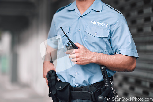 Image of Security guard, safety officer and man with walkie talkie in hand on street for protection, patrol or watch. Law enforcement, focus and duty with a crime prevention male worker in uniform in the city