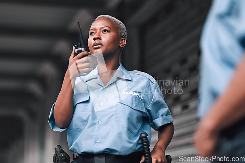 Image of Police, communication and black woman law enforcement worker talking on walkie talkie or radio for emergency. Security, legal and officer or employee doing criminal investigation for justice