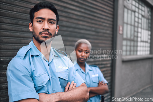 Image of Portrait, security or law enforcement and a serious man arms crossed with a black woman colleague on the street. Safety. focus and duty with a crime prevention unity working as a team in the city