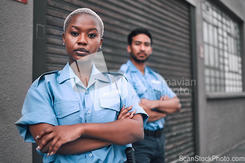 Image of Portrait of black woman, security guard or arms crossed of safety officer, protection service or team patrol in city. Law enforcement, focus or professional crime prevention people in uniform outdoor