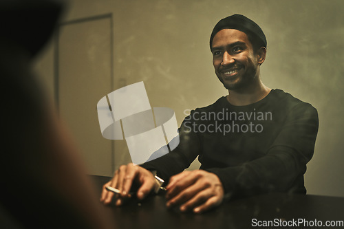 Image of Man, suspect smoking and detective in interrogation room with criminal, terrorist or interview with a gangster. Police officer, murder questioning and statement on crime and person with cigarette