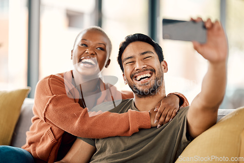 Image of Home, selfie and couple on a couch, smile and loving together with romance, profile picture and marriage. Social media, black woman or Asian man on a sofa, romantic and memory with happiness or relax