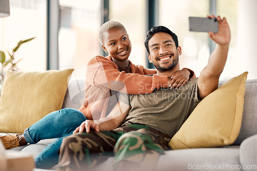 Image of Home, selfie and couple on a couch, love and happiness with romance, relationship and marriage. Social media, black woman and Asian man on a sofa, romantic and memory with profile picture and relax