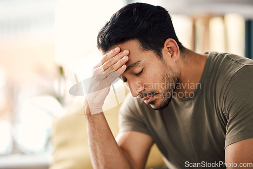 Image of Tired, headache and stress of man in living room with mental health, fatigue and sad problem. Face, depression and frustrated male person with anxiety, brain fog or crisis of failure, mistake or debt