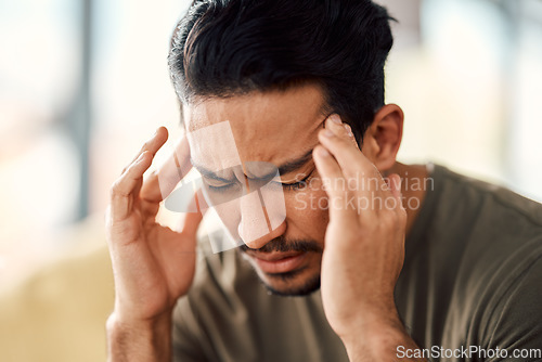 Image of Man, headache and pain in home from stress, mental health fatigue and mind problem. Face, sick and depression of frustrated male person in anxiety, brain fog and dizzy from failure, worry and vertigo