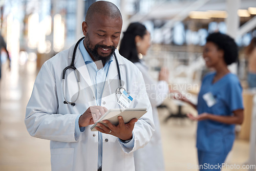 Image of Doctor, black man and tablet for medical planning, data research or healthcare app in busy hospital. Happy male surgeon, digital technology and consulting information on telehealth schedule in clinic