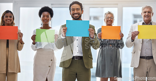 Image of Creative people, portrait and color poster for advertising, marketing or branding in teamwork at the office. Group of happy employees with colorful paper, sign or card for startup at the workplace