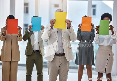 Image of Collaboration, paper and an anonymous business team standing in the office together to show selection options. Teamwork, mockup and color poster with a group of colleagues or employees at work