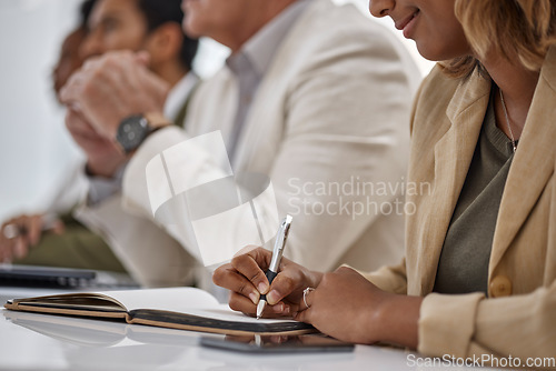 Image of Woman, hands and writing in book for meeting notes, information or minutes on office desk in boardroom. Hand of female person or employee in team planning, strategy or brainstorming in notebook