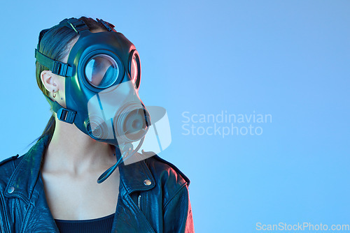Image of Mockup, protection and woman with a gas mask, breathing equipment and air pollution against a blue studio background. Female person, model and face cover with climate change, filter and radioactive