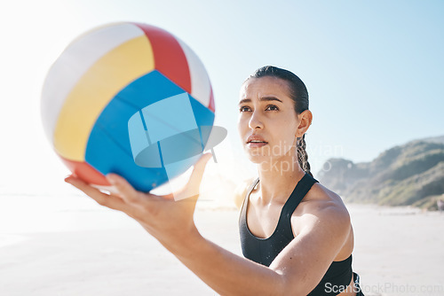 Image of Beach, exercise and woman with volleyball to serve for games, fun and sports in sunshine. Face of female person, athlete and player with focus holding ball to start contest for summer action at ocean