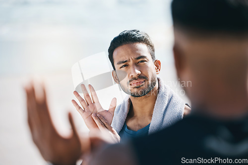 Image of Sign language, communication and friends talking on the beach during summer vacation or holiday together. Face, conversation and travel with a young man chatting outdoor in nature by the ocean