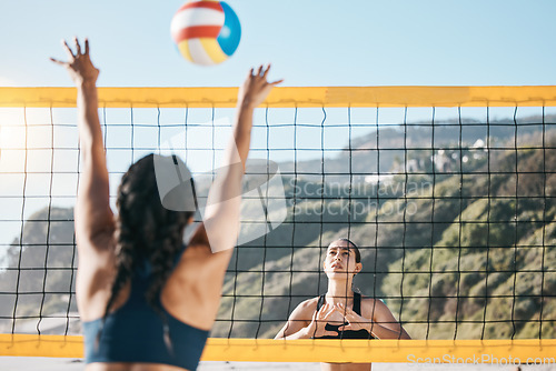 Image of Volleyball, women and spike, net with sports and fitness outdoor, playing game at the beach at summer. Exercise, female athlete and match with ball and active, workout and action with tournament