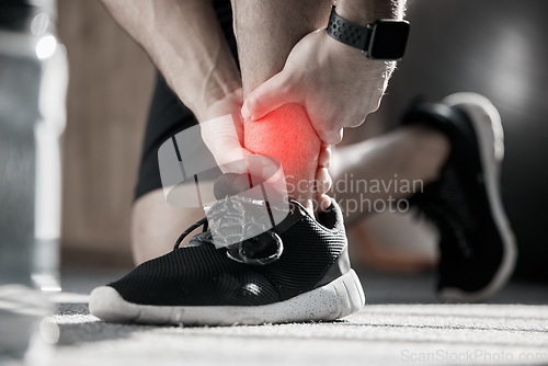 Image of Hand, ankle pain and injury with the leg of a man in red highlight during a fitness workout. Healthcare, medical and emergency with a male runner holding a joint after a cardio accident in the gym