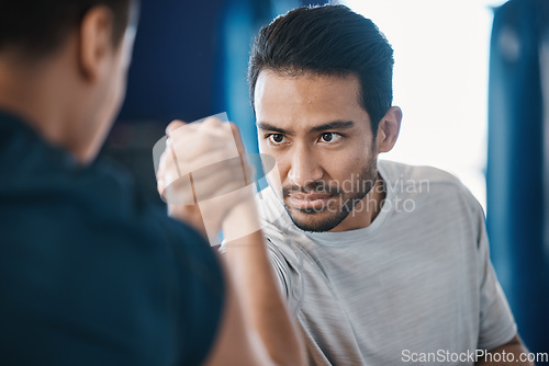 Image of Arm wrestling, men and strength challenge with strong muscle at a gym for battle. Hand wrestle, power and male friends or athletes together for sport, competition or contest with focus and commitment