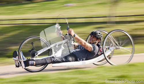 Image of Cycling, fitness and fast with man and handcycle in nature for training, sports and challenge. Exercise, workout and cardio with person with a disability in park for motion blur, marathon and health