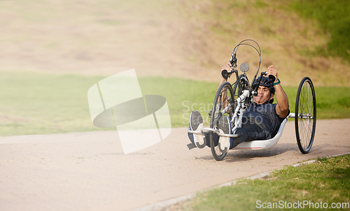 Image of Cycling, nature and speed, man with disability training for competition with motivation and exercise on bike. Motion, workout and person on fast recumbent bicycle for outdoor race, space and mockup.