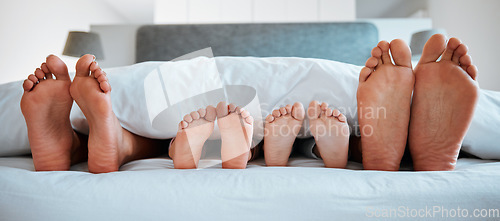 Image of Family feet, bed and blanket in closeup, parents or kids sleeping on holiday in morning, care and relax. Bedroom, people and sleep with mom, dad or children on vacation, home or break in hospitality