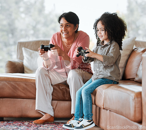 Image of Grandma, child and video game on couch, controller and happy together with bond, contest and love in lounge. Senior woman, young kid and playing with gaming, esports and competition in family house