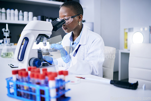 Image of Science, laboratory and woman on microscope for blood test research, medical analysis and dna or virus tube. Biotechnology, healthcare and scientist, doctor or african person check for particles