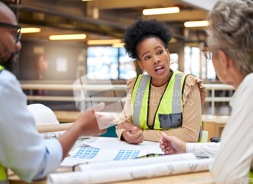 Image of Architecture, meeting or civil engineering team planning a blueprint of a building or construction in office. Teamwork, collaboration or group of designers talking, speaking or working on floor plan