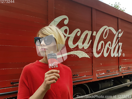 Image of Kyiv, Ukraine - July 6, 2017 Beautiful fashionable woman with model release drinking Coca-Cola soda