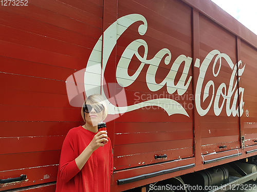 Image of Kyiv, Ukraine - July 6, 2017 Beautiful fashionable woman with model release drinking Coca-Cola soda