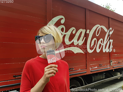 Image of Kyiv, Ukraine - July 6, 2017 Beautiful fashionable woman with model release drinking Coca-Cola soda