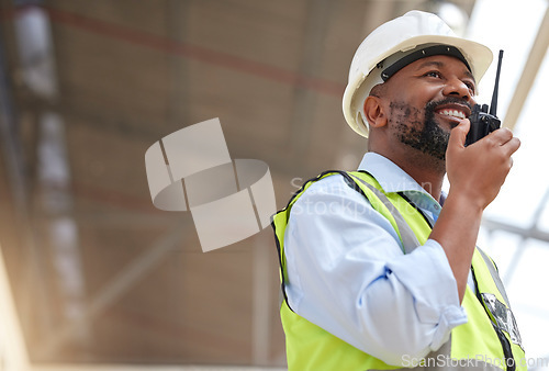 Image of Radio, black man and engineer planning, communication and construction. African architect, walkie talkie and happy contractor with industrial project, building maintenance and engineering discussion.