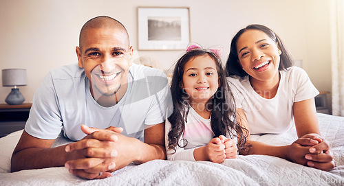 Image of Family, relax and portrait on a bed at home while happy and together for quality time. Man, woman or hispanic parents and a girl kid in the bedroom for morning bonding with love, security and care