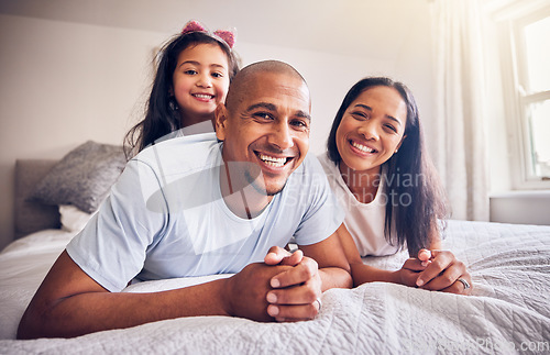 Image of Family, relax and happy portrait on a bed at home while happy and playing for quality time. Man, woman or hispanic parents and a girl kid together in bedroom for morning bonding with love and care