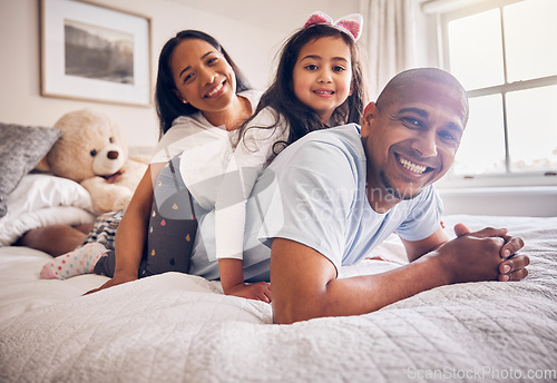 Image of Family portrait, morning and relax on a bed at home while happy and playing for quality time. Man, woman or hispanic parents and a girl kid together in the bedroom for bonding with love and care