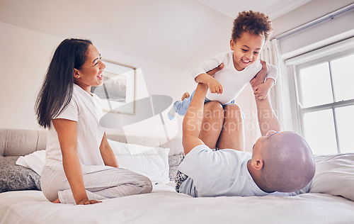 Image of Happy family, playing and dad with child on bed, bonding and airplane game for father and daughter time in home. Parents, love and playful energy, man holding girl in air and mom laughing in bedroom.