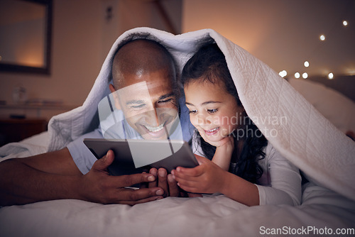 Image of Father, kid and smile with tablet at night under blanket of online games, reading ebook or storytelling app. Happy dad, girl child or watch cartoon movie on digital tech, media or internet in bedroom