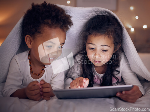 Image of Games, night and children with a tablet in bed for cartoon, movie or streaming a show. Smile, blanket and girl kids with technology in the bedroom for the internet, education or online fun together