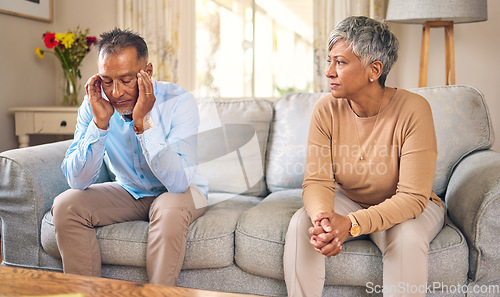 Image of Senior couple, stress and divorce in fight, conflict or argument for disagreement on living room sofa at home. Elderly man and woman in depression, infertility or toxic relationship in the house
