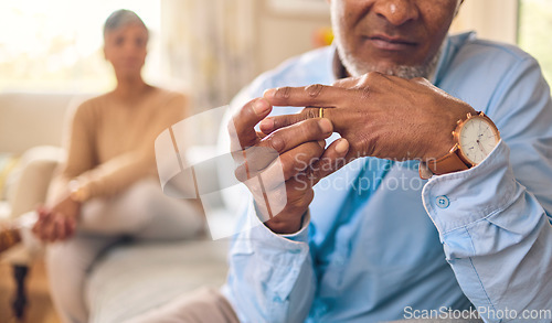 Image of Elderly couple, hands and ring in divorce, fight or conflict from disagreement or argument on sofa at home. Senior man and woman in depression, infertility or cheating and toxic marriage in the house