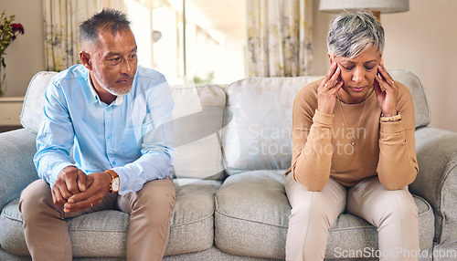 Image of Senior couple, divorce and fight in conflict, argument or disagreement on living room sofa at home. Elderly man and frustrated woman in depression, infertility or toxic relationship in the house