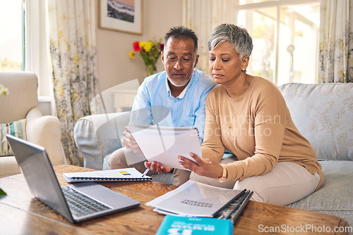 Image of Laptop, documents and finance with a senior couple in the home living room for retirement or budget planning. Computer, accounting or investment savings with a mature man and woman in a house