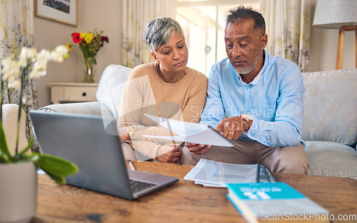 Image of Laptop, documents and payment with a senior couple in the home living room for retirement or budget planning. Computer, financial or investment savings with a mature man and woman in a house