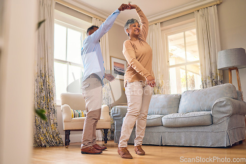 Image of Retirement, romance and dance with a senior couple in the living room of their home together for bonding. Marriage, love or fun with an elderly man and woman dancing in the lounge of their house