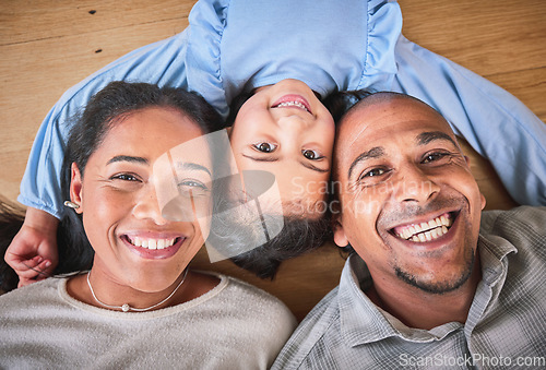 Image of Face, family and smile in home top view, bonding and having fun on floor in house. Portrait, parents and happy child, mother and father with love, relax on ground and enjoying quality time together.