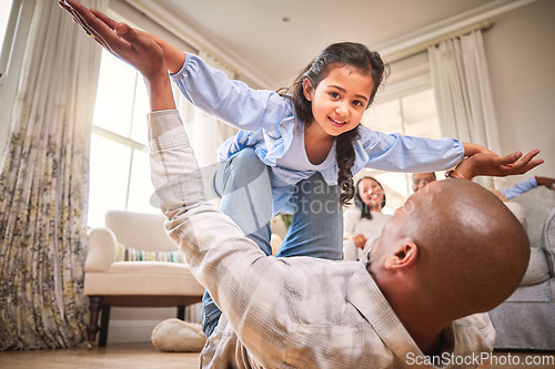 Image of Family, fun and a daughter flying with dad on the floor of a living room in their home together for bonding. Smile, children and portrait a happy girl playing fantasy games her father in their house