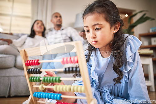 Image of Child, toys for learning and education in family home with abacus on the floor or mom, dad and girl relax in living room with a game. Kid, development in math and couple together on couch in house