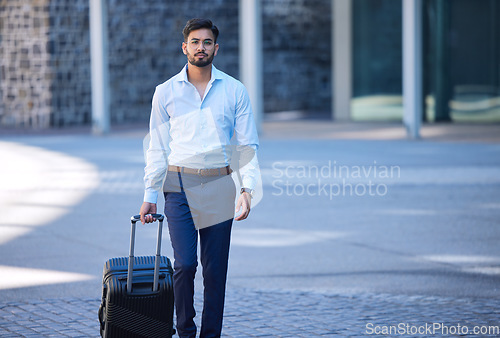 Image of Portrait, travel and a businessman with a suitcase in the city for a holiday or work trip in Singapore. Serious, worker and a male employee with luggage in town for a corporate journey or vacation