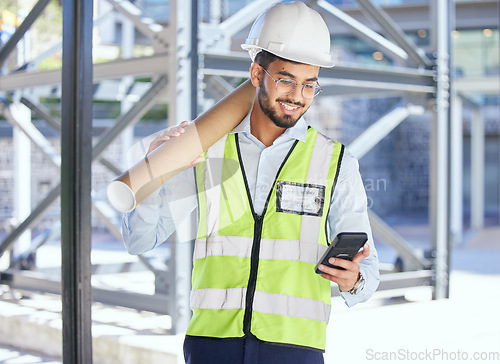 Image of Architecture, phone typing and happy man with blueprint at construction site, networking and communication with text. Engineering, cellphone and checking email with safety and planning with smile.