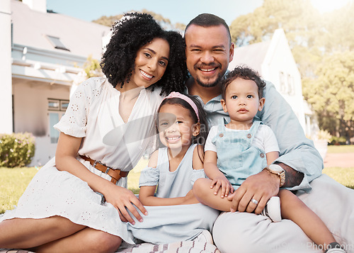 Image of Portrait, blended family and parents on the lawn with their children in the garden of their home together. Mother, father and kids sitting on the grass in the yard of their house for love or bonding