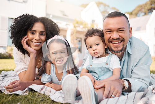 Image of Portrait, blended family and parents on the lawn with their kids in the garden of their home together. Mother, father and children lying on the grass in the yard of their house for love or bonding