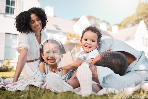 Image of Love, blended family and parents on the lawn with their children in the garden of their home together. Mother, father and portrait of kids sitting on the grass in the yard of their house for bonding