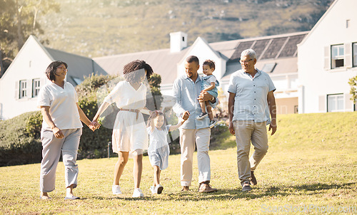 Image of Holding hands, children and a blended family walking in the garden of their home together during summer. Grandparents, parents and kids on grass in the backyard of a house for bonding during a visit